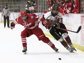 Chatham Maroons' Owen Sculthorp, right, and Leamington Flyers' Ryan Clark battle at Chatham Memorial Arena in Chatham, Ont., on Saturday, Dec. 4, 2021. Mark Malone/Chatham Daily News/Postmedia Network