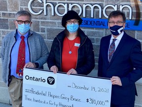 Bruce Grey Owen Sound MPP Bill Walker, right, brought a jumbo cheque to Residential Hospice of Grey Bruce Tuesday, Dec. 14, 2021. Paul Rowcliffe, past board chair, and Janet Fairbridge, the executive director, joined him for a photo. (Supplied to The Sun Times/Postmedia Network)