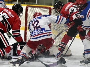 Mitchell Hawks' goalie Tyler Parr can be seen reaching for the puck through the legs of Gavin Downs (12) of the Kincardine Bulldogs during late third period action of their PJHL regular season game Nov. 28 in Mitchell. Sean Chisholm (15) and Callum McMann (21) of the Hawks and Jordan Beisel (24) of the Bulldogs are also pictured. Kincardine won, 3-2 in overtime, rallying from a late 2-0 deficit. ANDY BADER/MITCHELL ADVOCATE