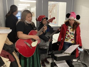 Volunteers sing at Father Turcotte School, where the Fort McMurray Knights of Columbus gave out Christmas meals on Dec. 25, 2021. Supplied Image/Larry Andrews