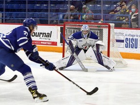 Sudbury Wolves goalie Mitchell Weeks (70) prepares to make a save on Mississauga Steelheads defenceman Ethan Del Mastro (77) during first-period OHL action at Sudbury Community Arena in Sudbury, Ontario on Friday, December 31, 2021.