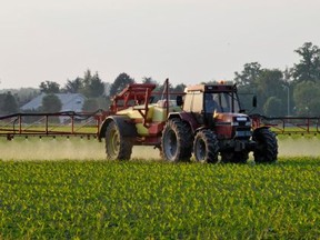 Agricultural machinery spraying the crops with pesticides.
