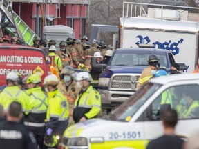 Scores of emergency personnel converge on the site of an apartment building under construction at 555 Teeple Terrace in London after it partially collapsed on Dec. 11, 2020. Two workers were killed and five others were injured. Two Southwestern Ontario companies that were working on the site and one person who was not named face workplace safety charges, Ontario's Labour Ministry said Monday. (Derek Ruttan/The London Free Press)