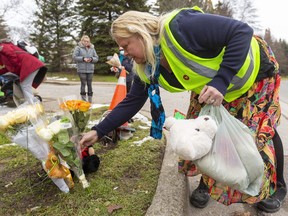 Londoners have started placing flowers at the spot along Riverside Drive in London where 10 people, including several children, were struck by a vehicle while walking on Tuesday night. A girl, 8, has died of her injuries. Photo taken Wednesday Dec. 1, 2021. (Mike Hensen/The London Free Press)