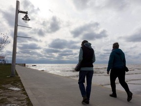 Mary Lynch and Donna Gilbert walk on the pier in Port Stanley. Environment Canada issued a special weather statement Thursday warning of heavy rain and strong winds in Southwestern Ontario beginning Friday evening and continuing Saturday, when gusts could reach 70 km-h. (Mike Hensen/The London Free Press)
