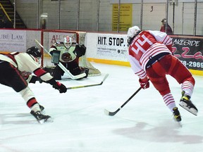 Photo by KEVIN McSHEFFREY/THE STANDARD
Elliot Lake Red Wings Jovani Moses scores his second goal of the game against Blind River Beavers goaltender Gavin Disano on Friday evening at the Centennial Arena.