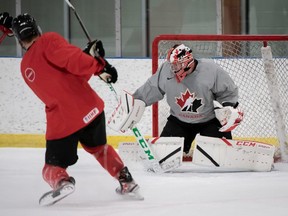 Team Canada goalie Brett Brochu of Tilbury, Ont., makes a save during a national junior hockey team practice at the Fenlands Banff Recreation Centre in Banff, Alta., on Monday, Dec. 20, 2021. (Matthew Murnaghan/Hockey Canada Images)