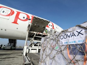 FILE PHOTO: Ethiopian Airlines staff unload AstraZeneca/Oxford vaccines under the COVAX scheme against the coronavirus disease (COVID-19) from a cargo plane at Bole International Airport in Addis Ababa, Ethiopia, March 7, 2021. REUTERS/Tiksa Negeri/File Photo ORG XMIT: FW1