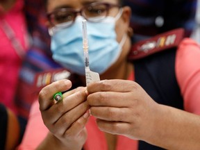 A health-care worker holds the Johnson & Johnson vaccine.