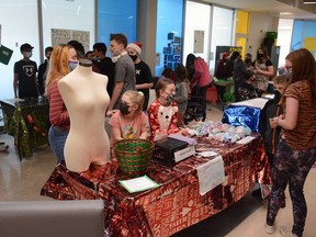 Grade four and five students sell tie-dye clothing in support of Bethany Airdrie during the Herons Crossing Christmas Fair on December 9.Photo by Riley Cassidy/The Airdrie Echo/Postmedia Network Inc.
