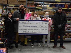 Petra Mace, Corey Mace, Maleena Mace, Christine Taylor, Lori McRitchie, and Elmakssoudi Abdelghani stand with a big cheque presenting the results of the Corey Mace Turkey Drive in 2021.