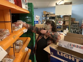 Ashley Singleton stocks shelves at the Brantford food bank.