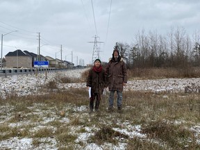 Ella Haley and her husband, Richard Tunstall, stand on farmland at Powerline and Rest Acres roads near Paris with a housing development in the background. Haley is urging Brant county councillors to protect farmland as they consider endorsing a new official plan for the municipality.