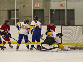 Players watch as a shot by Naren Parker of the Paris Panthers rolls past BCI goalie Abi Couschene into the net late in the third period to give Paris a 4-0 lead, in a high school girls hockey game on Wednesday December 8, 2021 at the Brant Sports Complex in Paris, Ontario.