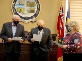 David Beatty, left, and Phil Deery recite the oath of office in unison before Brockville clerk and interim city manager Sandra MacDonald in the main council chamber Friday afternoon, as they are officially sworn in as Brockville's newest councillors. (RONALD ZAJAC/The Recorder and Times)