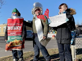 Shyanne MacDonald, left, Anna Ladd and Mandy Carr, Grade 9 students at St. Mary Catholic High School, were outside Friday morning drawing attention to the school's canned food drive to support local food banks. (MARSHALL HEALEY/The Recorder and Times)