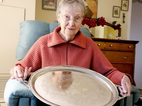 Tina Harney poses with a silver tray given to her parents by the officer they sheltered after the Halifax Explosion in 1917. (RONALD ZAJAC/The Recorder and Times)