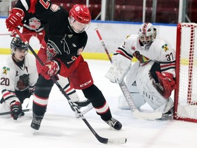 Brockville defenceman Anthony Biniaris tries to disrupt Pembroke's Jacob Zwirecki while goalie Sami Molu keeps an eye on the puck during the Braves-Lumber Kings game in Pembroke on Sunday night. Brockville edged the Lumber Kings 5-4 to take both ends of a home-and-home. 
Tina Peplinskie/Postmedia Network