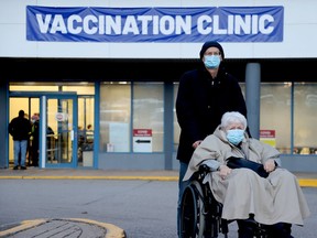 Heike and Bert Meier, of Maitland, leave the Brockville COVID-19 vaccination clinic after getting their booster shots on Friday afternoon, Dec. 17. The clinic was a busy place, with lineups at the door. (RONALD ZAJAC/The Recorder and Times)