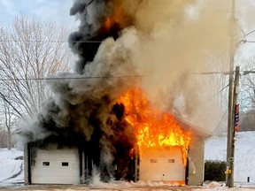 Fire engulfs the Rideau Lakes Township fire station in Portland on Dec. 21, 2021 in this image taken by Wendy MacNay. (SUBMITTED PHOTO)