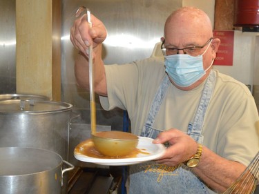 Branch 97 President Eric Place prepares the gravy at the Royal Canadian Legion in Prescott on Saturday. It was King's Kitchen's eighth annual Christmas dinner, which switched from in-person to delivery because of the recent surge in COVID-19 cases.
Tim Ruhnke/The Recorder and Times