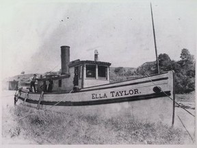 The Ella Taylor docked on the north river bank, just west of Fifth Street Bridge. The white building in the background is an ancient hotel that later became a boarding house, but correct name in not known. John Rhodes