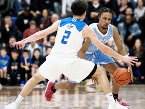 Lambton Lions' Journee Joseph, right, loses the ball while being guarded by George Brown Huskies' Robert Ocampo in the second quarter of an OCAA men's basketball quarter-final at Lambton College's Athletics & Fitness Complex in Sarnia, Ont., on Friday, March 6, 2020. Mark Malone/Chatham Daily News/Postmedia Network