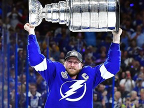 Tampa Bay Lightning captain Steven Stamkos hoists the Stanley Cup after a 1-0 victory against the Montreal Canadiens in Game 5 to win the Stanley Cup final at Amalie Arena on July 7, 2021, in Tampa, Fla. (Julio Aguilar/Getty Images)