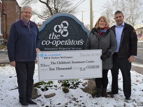 From left to right, Children's Treatment Centre president Don Fairweather accepting a $10,000 donation for the second year in a row from Darlene and Bill McGimpsey, owner and operator of Co-Operators Insurance Inc on Tuesday November 30, 2021 in Cornwall, Ont. Shawna O'Neill/Cornwall Standard-Freeholder/Postmedia Network