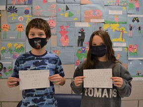 From left, Grade 6 Bridgewood Public School students Pheonix Favel and Lilah Newton showing off their Be Kind messages on Monday December 6, 2021 in Cornwall, Ont. Shawna O'Neill/Cornwall Standard-Freeholder/Postmedia Network