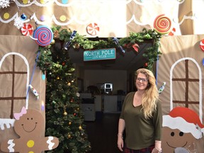 NuMed employee Tanya Chisholm stands with one of the Christmas displays at the 45 Pitt St. office on Thursday December 16, 2021 in Cornwall, Ont. Shawna O'Neill/Cornwall Standard-Freeholder/Postmedia Network