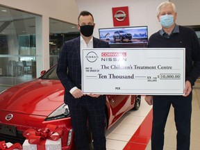 Cornwall Nissan manager Spencer Roberts (left) and Children's Treatment Centre president Don Fairweather. Photo on Monday, December 27, 2021, in Cornwall, Ont. Todd Hambleton/Cornwall Standard-Freeholder/Postmedia Network