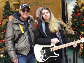 Recording artist John McIntosh, with Cornwall's Leena Wotherspoon, recipient of his personal Fender Stratotocaster guitar. Photo on Friday, December 24, 2021, in Cornwall, Ont. Todd Hambleton/Cornwall Standard-Freeholder/Postmedia Network