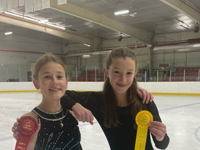 Devon Skating Club members Makaylah Kuchirka (left) and Rachel Ott show their ribbons from the Edmonton Region STARSkate Open Competition in St. Albert. (Devon Skating Club)