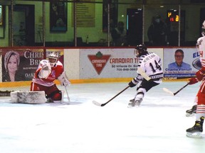 Photo by KEVIN McSHEFFREY
PIX 40- Espanola Express' Ty McHutchion scored his team's fourth goal of the game against Elliot Lake Red Wings netminder Cameron Smith on Saturday evening at the Centennial Arena.