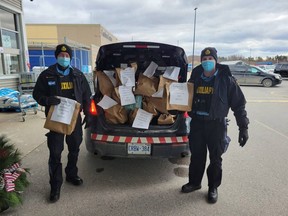Huron OPP Auxiliary Unit officers stuffing their cruiser thanks to generous donations from the community. Submitted