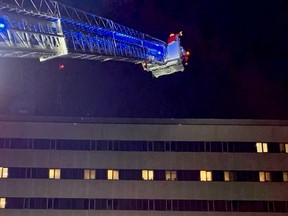 Santa waves at patients and staff inside of the Owen Sound hospital from the bucket of the city fire department's 100-foot aerial platform truck. SUPPLIED