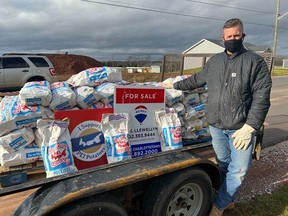 Paul Llewellyn from Remax Charlottetown set up a truckload of 20 lb potato bags and handed them out to Islanders on November 28.
