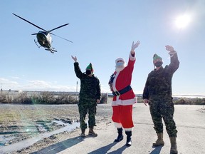 Santa Claus and a couple of Canadian Forces members from 1 Wing Headquarters at Canadian Forces Base Kingston arrive to deliver presents to pediatric patients at Kingston Health Sciences Centre as their ride, a Griffon helicopter from 400 Tactical Helicopter Squadron, lifts off  in Kingston, Ont., on Friday, Dec. 3, 2021. 
Elliot Ferguson/The Kingston Whig-Standard/Postmedia Network