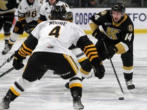 Kingston Frontenacs Jordan Frasca tries to get past the Hamilton Bulldogs' Lucas Moore in Ontario Hockey League action at the Leon's Centre on Friday. Frasca scored once in that game and then posted consecutive three-goal games on Saturday and Sunday.