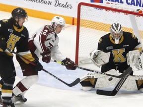 Peterborough Petes' Jaden Reyers attempts to deflect the puck at Kingston Frontenacs' goaltender Aidan Spooner in first-period Ontario Hockey League action on Thursday in Peterborough