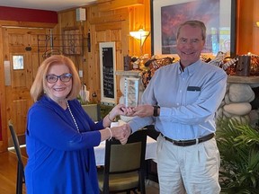 Above, Dr. Deb McNaughton of the Rotary Club of Grand Bend presents Dr. Peter Englert with the club's annual Community Award, which is presented to those who have made a significant contribution to the community.