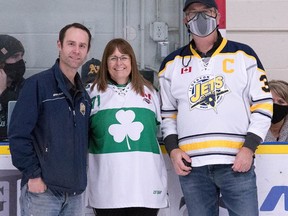 The Ilderton Minor Hockey Association (IMHA) and Lucan Irish honoured longtime hockey volunteer Rob Andrews, right, at a Lucan Irish game held at the Ilderton Arena on Sat., Dec. 4. Also pictured are IMHA president Mike Harding and Lucan Irish president Sandra Neubauer, who presented Andrews with an official Irish puck before the game.