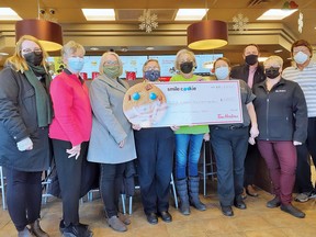 Volunteers Danielle Kryzanowski, Nancy Gerhart, Diane Paquette, Bernie Houle, Susan Kryzanowski, store manager Crystal Poirier, Tim Horton's owner, Al Martin, regional manager Crystal Dorian and volunteer Grant Lewis.