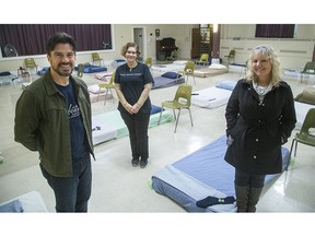 Joseph Lawrence, pastor of First-St. Andrews United Church on Queens Avenue, Sarah Campbell, executive director of Ark Aid Street Mission, and Debbie Kramers, the city of London's manager of co-ordinated informed response, show the new overnight "resting spaces" set up in the basement of First-St. Andrews that allow people to come in out of the cold. The shelter opened Monday. (Mike Hensen/The London Free Press)