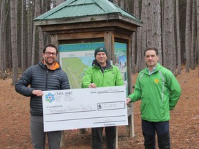 A group from CNL recently presented a check for $5,000 to Les Coureurs de Bois Running Club of Petawawa to recognize and assist financially with all the hard work Les Coureurs de Bois Running Club has done over the past seven years in maintaining and upgrading the trails in Petawawa Terrace Provincial Park. Their work has included mowing, whippersnipping, pruning, clearing fallen trees, spreading aggregate, removing stumps, building bridges and boardwalks and keeping trails clear and safe. The $5,000 will go towards the purchase of 30 steel u-channel posts to support a series of wayfinding trail signs that will be installed in the spring of 2022 and for the purchase of untreated cedar lumber and hardware for the continued construction of boardwalks in the park. The funds will also assist in modernizing the main trail maps on the kiosks throughout the park. The funds were provided by Canadian National Energy Alliance (CNEA), CNL's parent company, for CNL staff to invest in social causes and projects in their local communities. In the photo from left, Philip Kompass, section head employee communications CNL, and Rick Schroeder and Gary Serviss of Les Coureurs de Bois Running Club. Anthony Dixon
