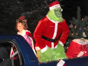 Cindy Lou Who smiles at the crowds lining the parade route while the Grinch sneers in this scene from the Dr. Seuss' story How the Grinch Stole Christmas. Anthony Dixon
