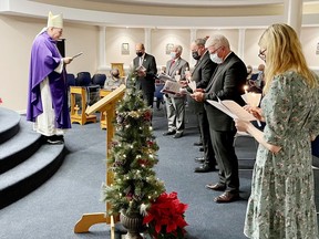 His Excellency Bishop Guy Desrochers celebrated mass and the rite of renewal for trustees in the Bishop Smith Catholic High School chapel, prior to the RCCDSB inaugural meeting on Dec. 6. Bob Schreader (second from left) was re-elected as chairman and David Howard (fourth from left) will continue in the role of vice-chairman.