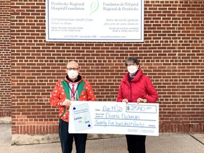 Roger Martin, executive director of the Pembroke Regional Hospital Foundation, presents a cheque for $2,540 to Diana Dockman, the winner of the Week No. 20 draw for the Catch the Ace 3.0 draw.