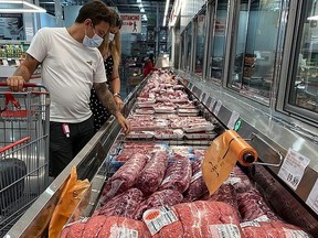 A couple look over cuts of beef in this file photo.
(REUTERS/Adrees Latif)